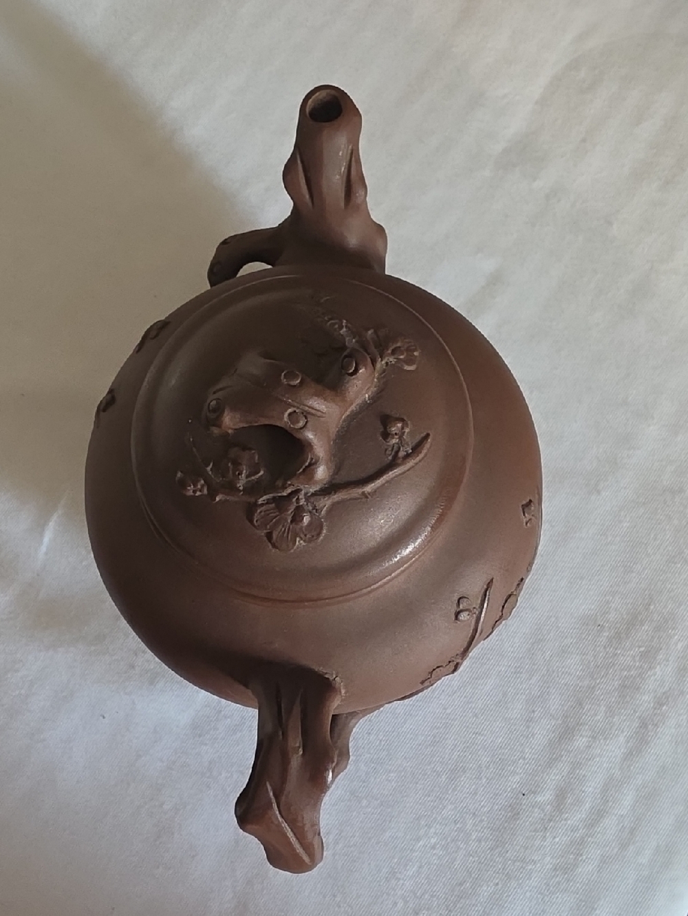 Chinese Yixing Zisha teapot decorated with plum blossom branches.
